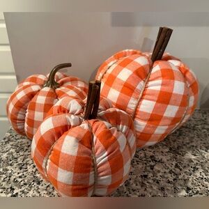 Three orange buffalo check soft pumpkins